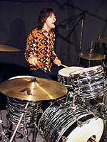 Kurt playing drums and singing